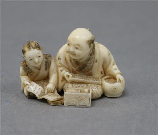 A Japanese ivory netsuke of a teacher and pupil